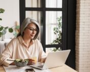 50+ court reporter receiving a direct deposit on laptop
