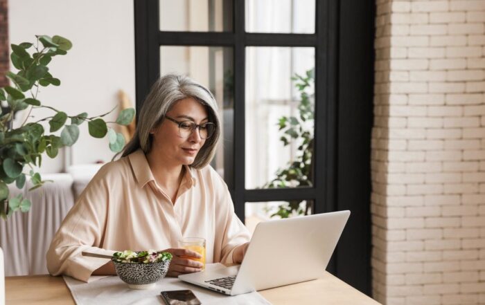 50+ court reporter receiving a direct deposit on laptop
